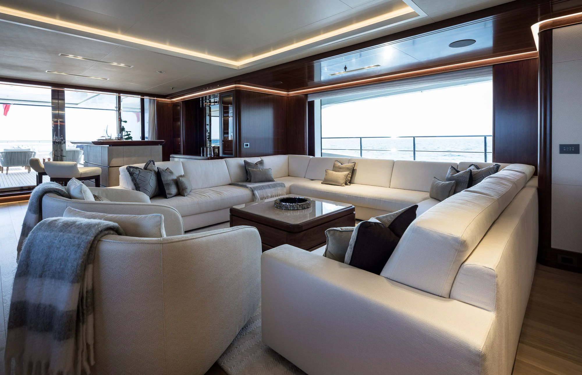 a living room with couches and a table aboard CALEX Yacht for Sale