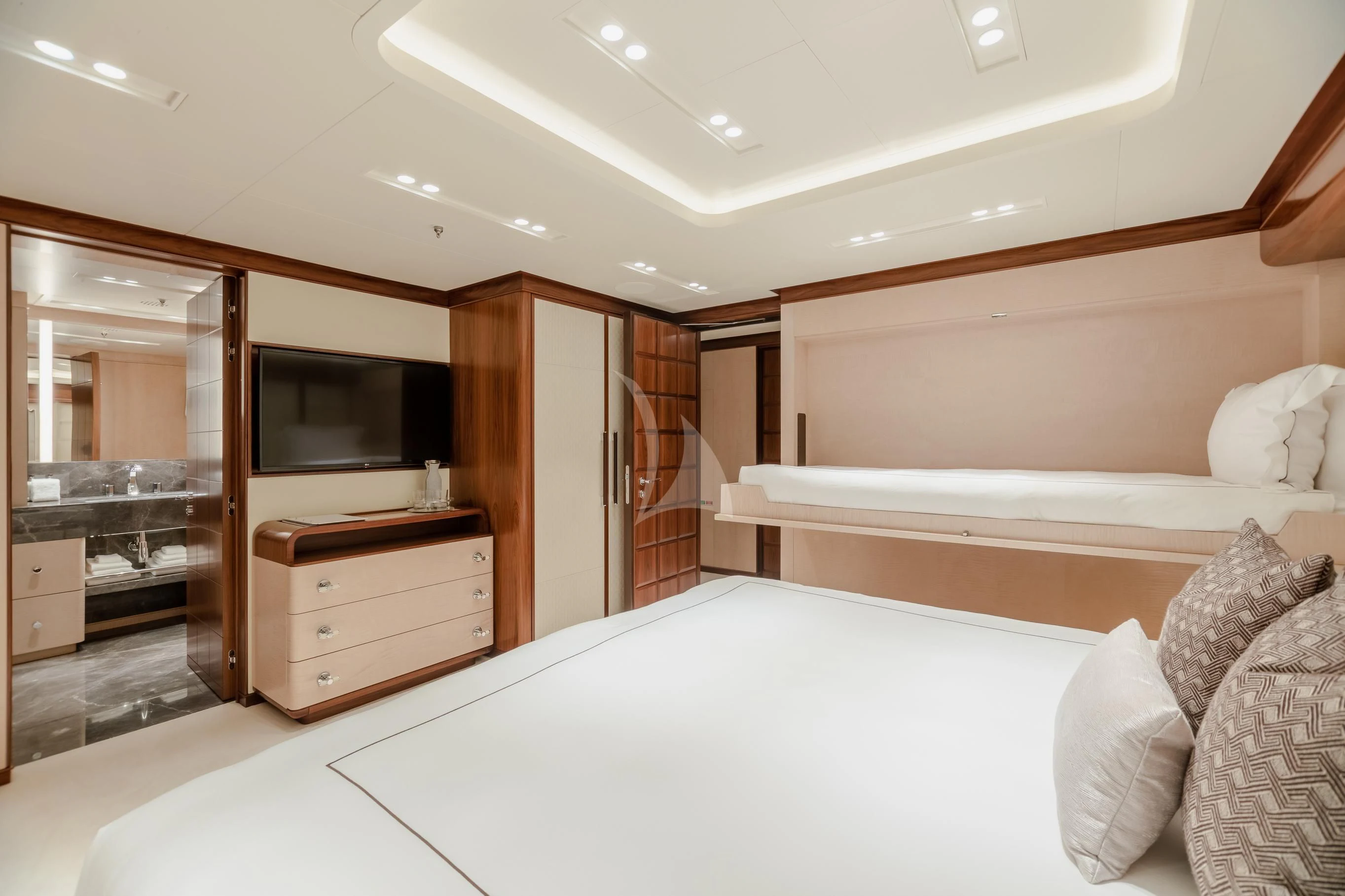 a bedroom with a bed and a television aboard CALEX Yacht for Sale