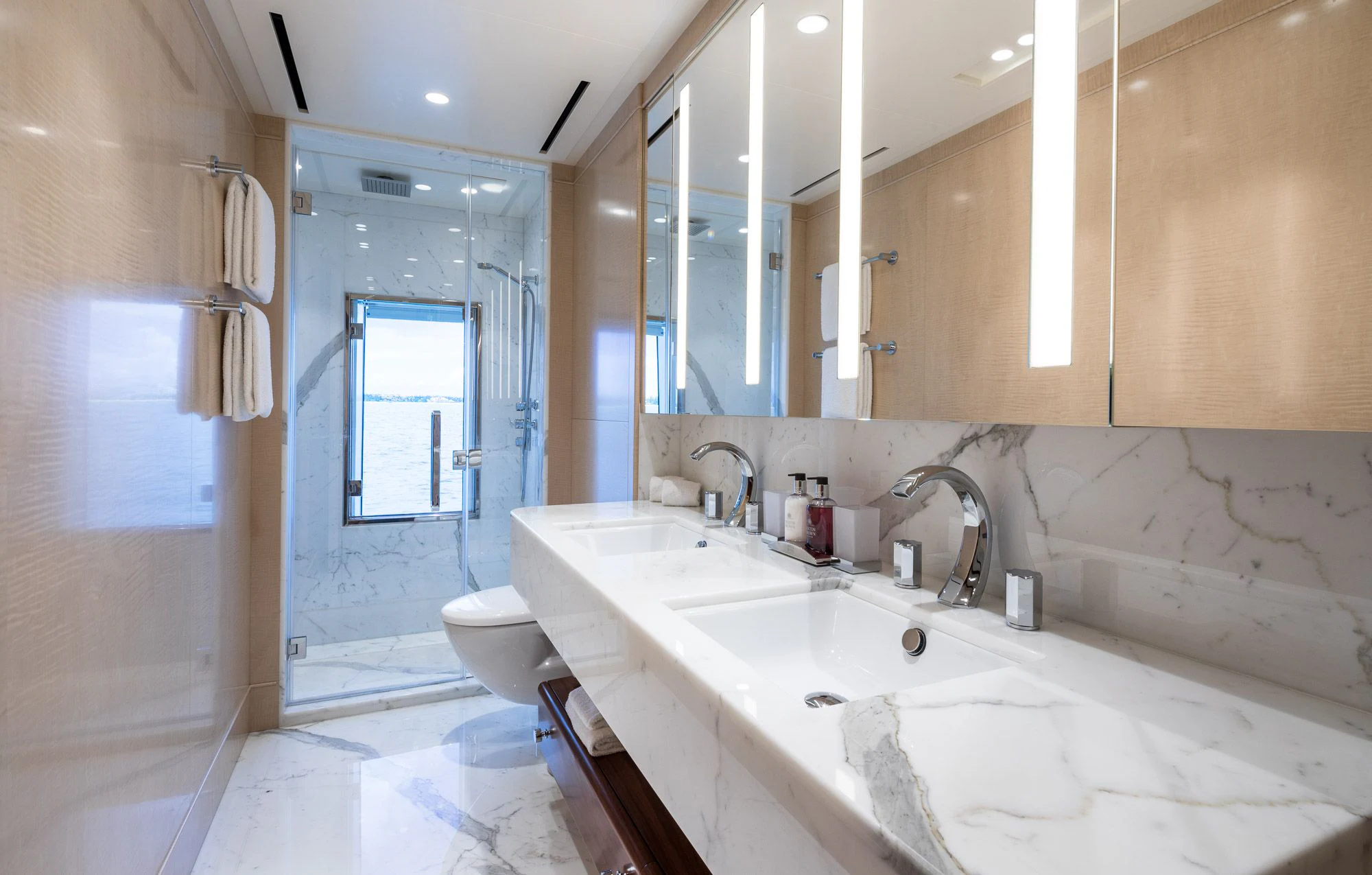 a bathroom with a tub sink and toilet aboard CALEX Yacht for Sale
