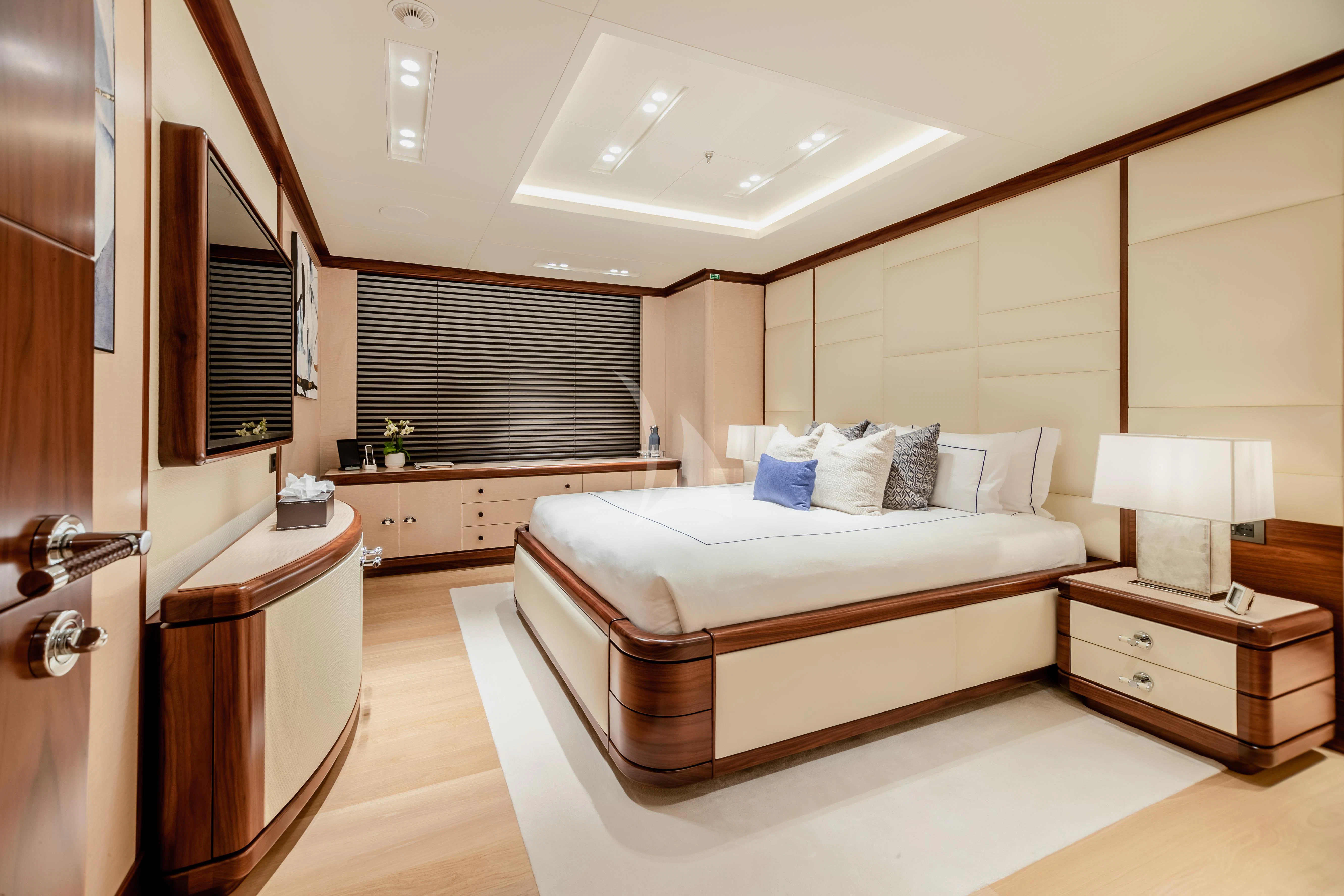 a bedroom with a bed and a desk aboard CALEX Yacht for Sale