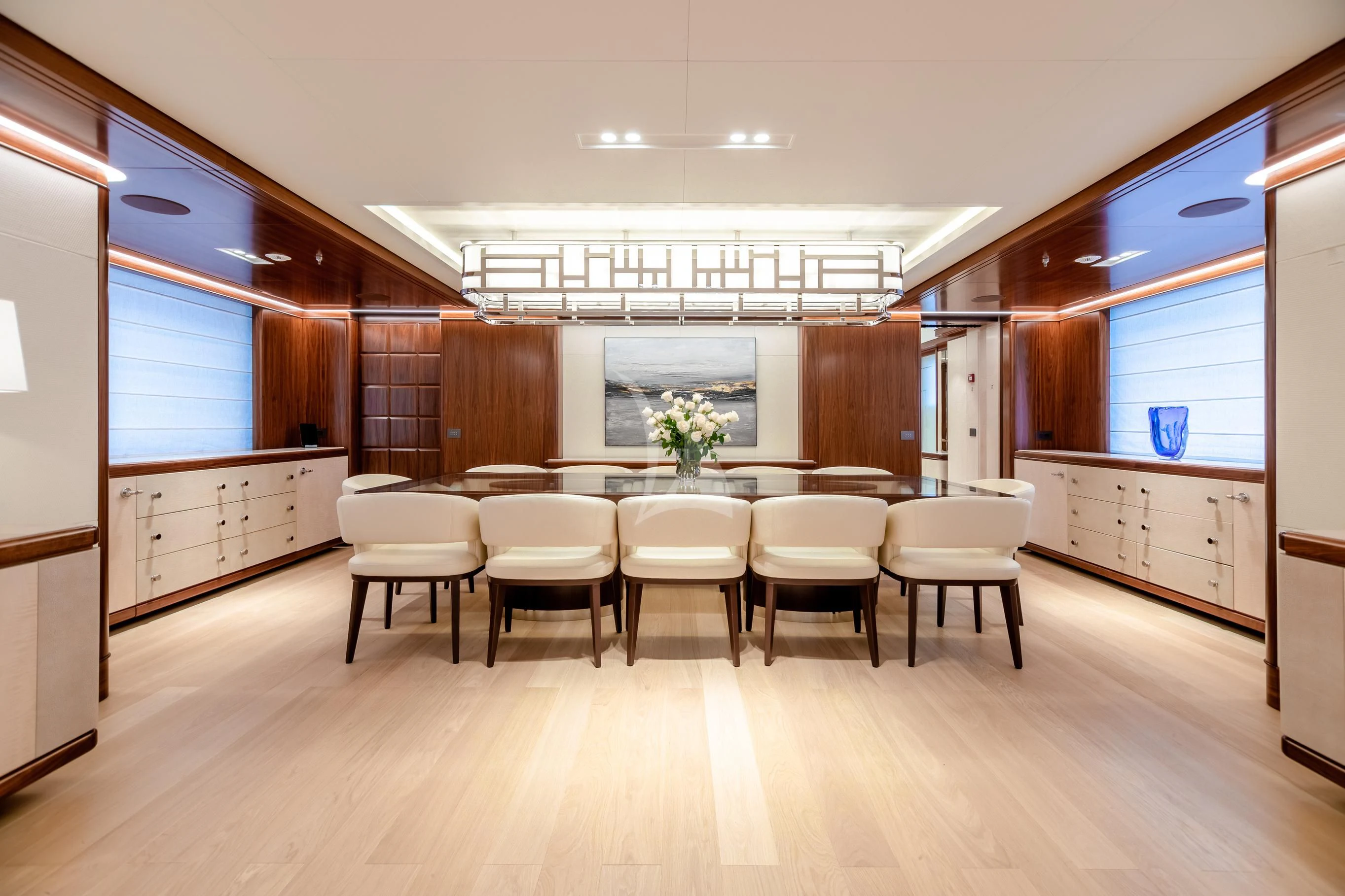 a room with a table and chairs aboard CALEX Yacht for Sale