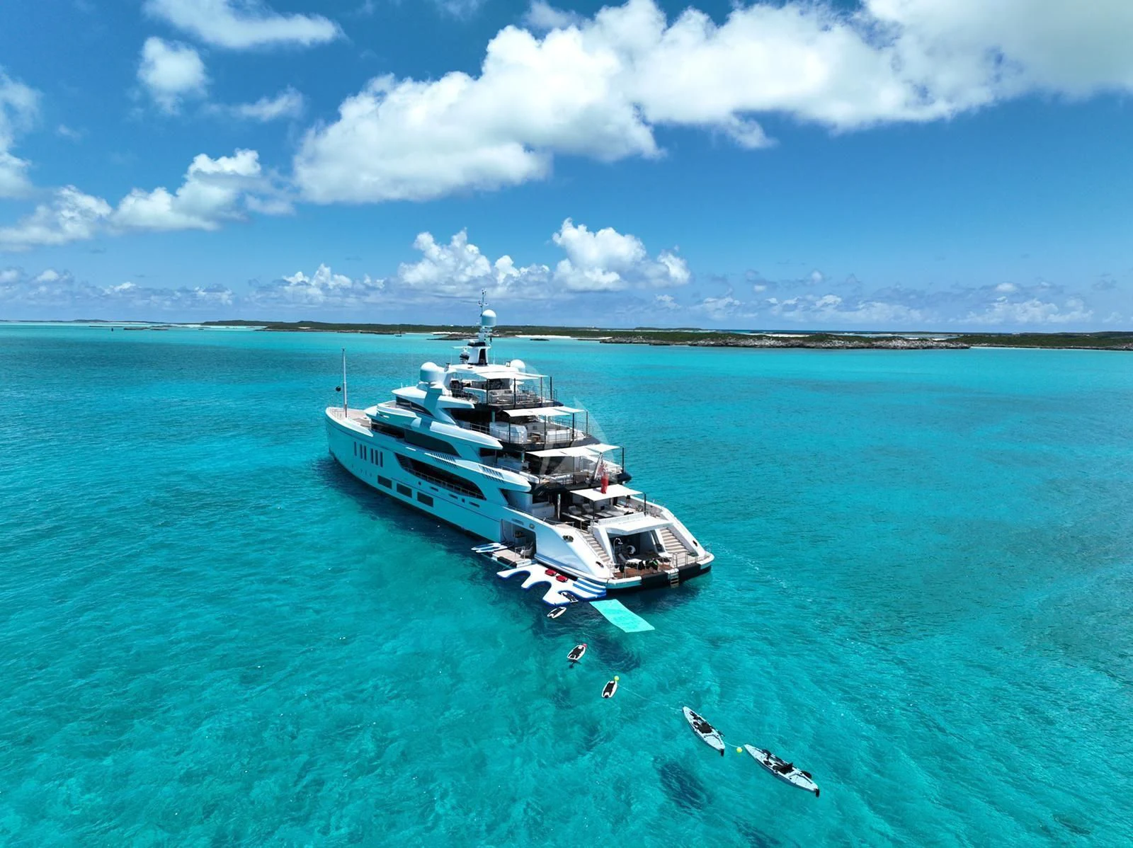 a helicopter flying over a large military ship in the ocean aboard CALEX Yacht for Sale