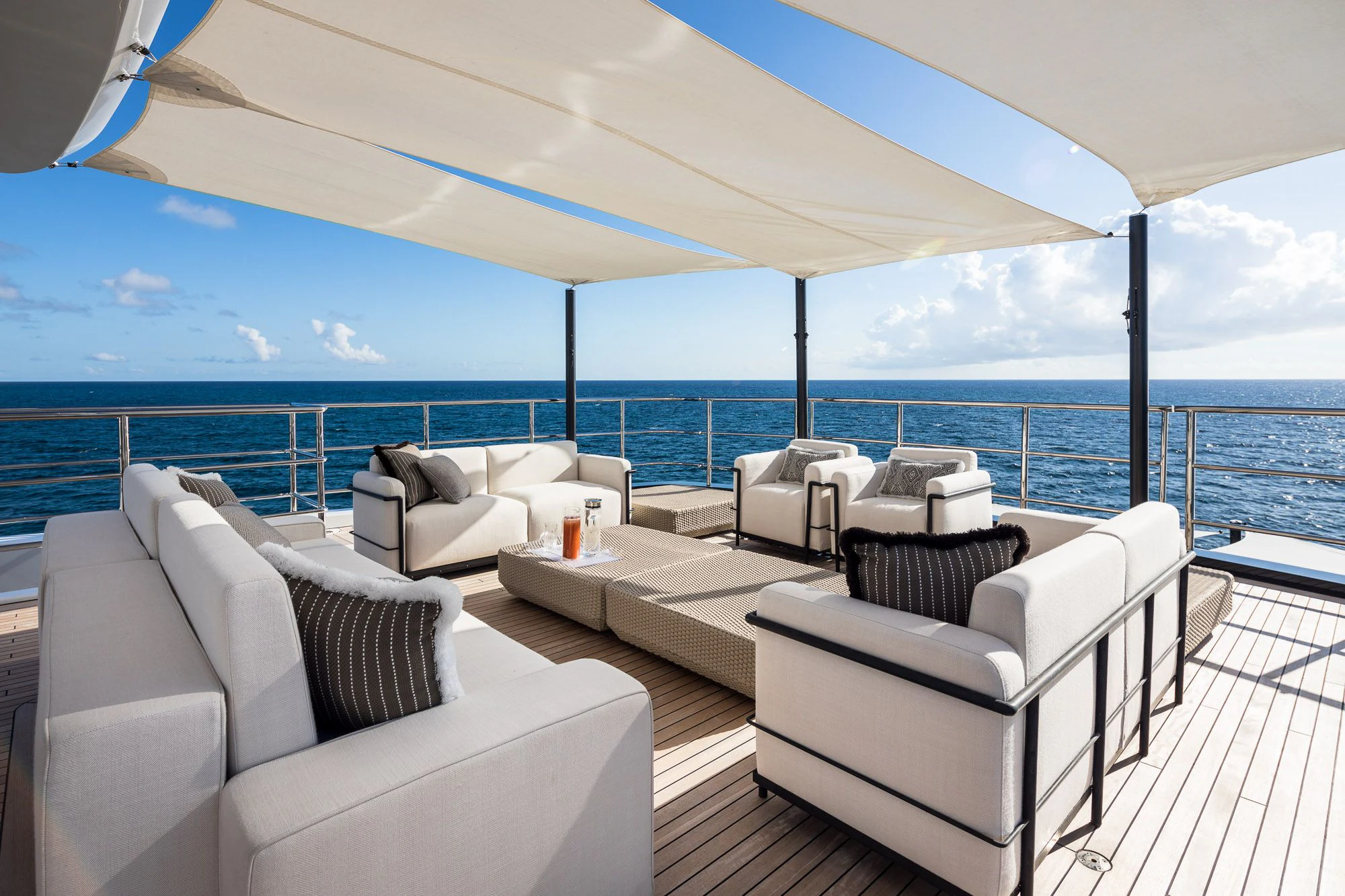 a large living room with a view of the ocean aboard CALEX Yacht for Sale