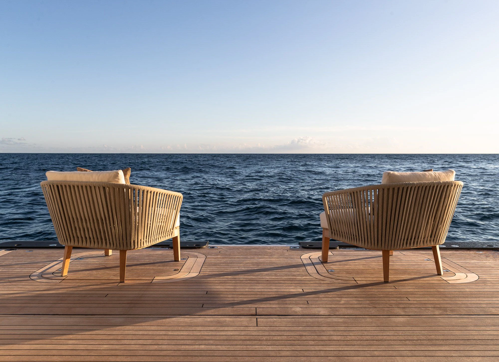 two chairs on a deck overlooking the ocean aboard CALEX Yacht for Sale