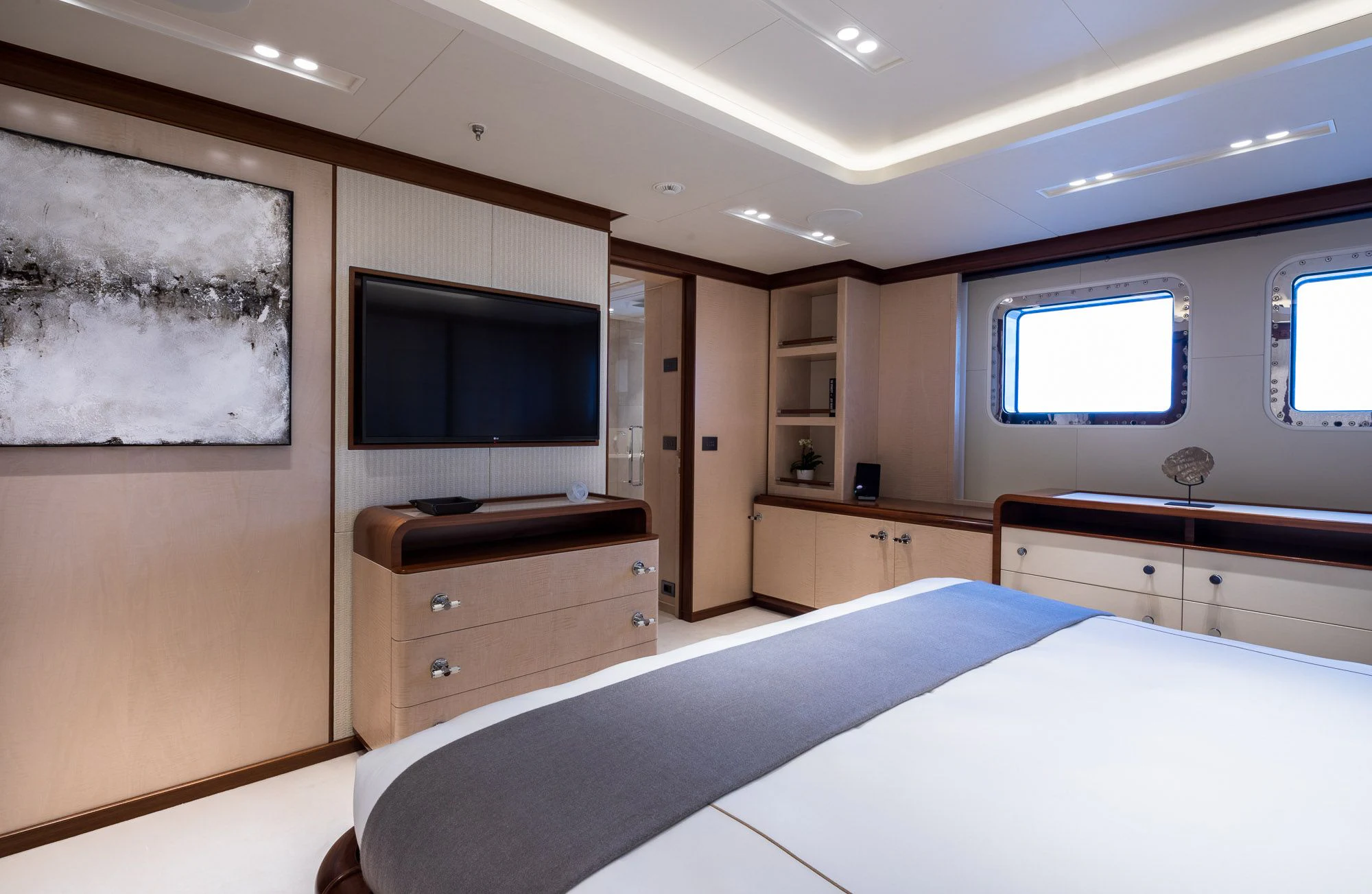 a bedroom with a bed and a tv aboard CALEX Yacht for Sale