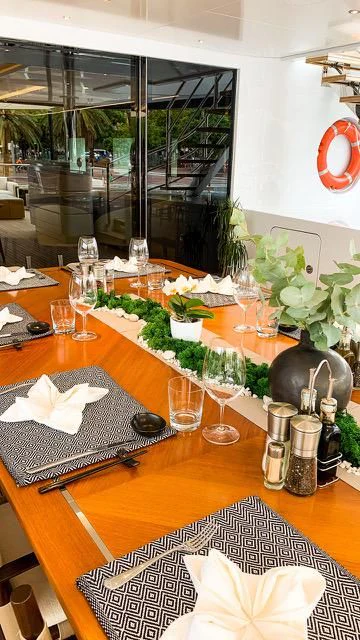 a table with wine glasses and bottles aboard CALEX Yacht for Sale