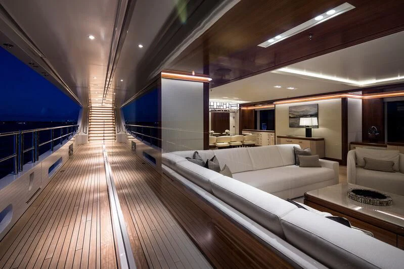 a large living room with a wood floor aboard CALEX Yacht for Sale