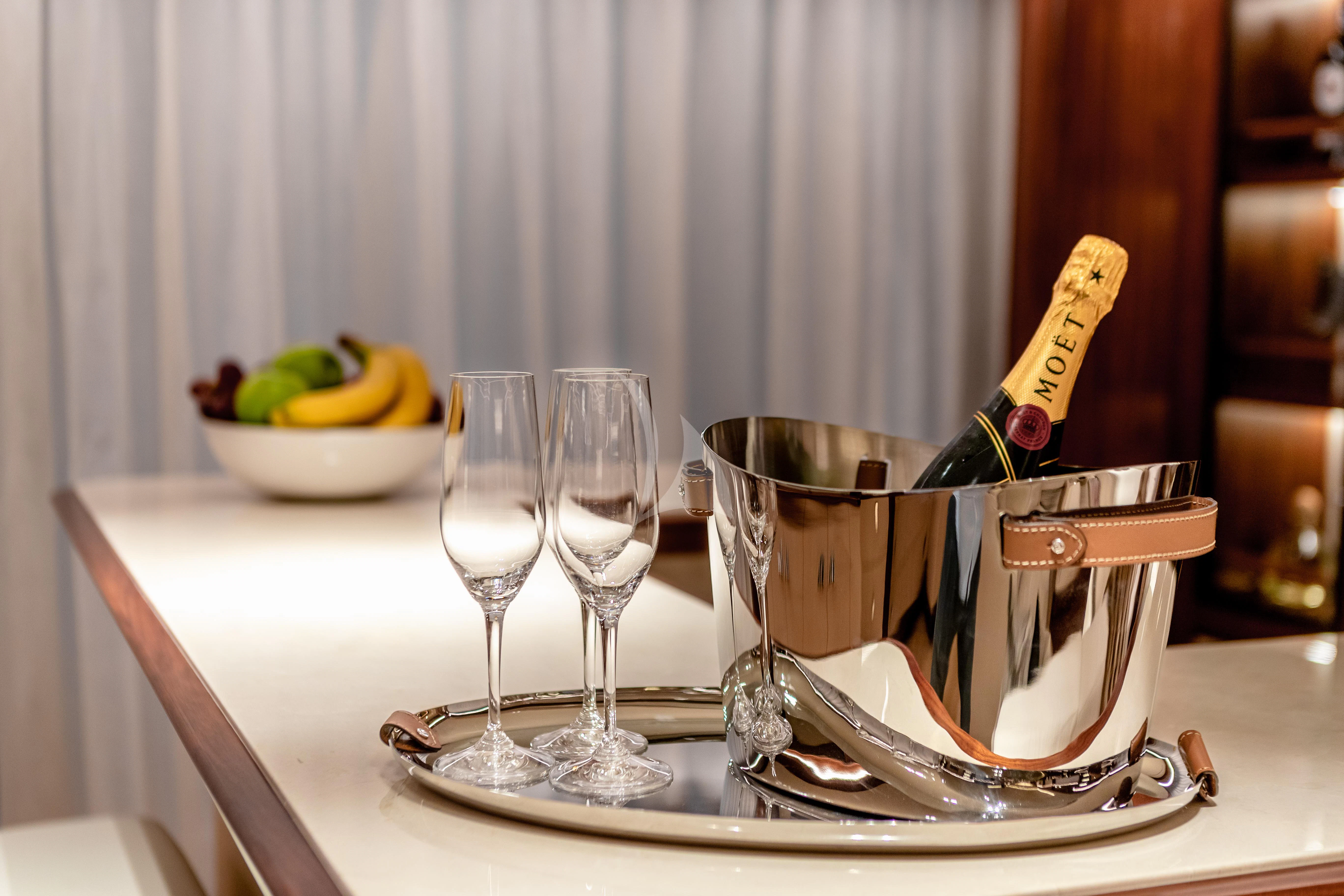 a table with wine glasses and a bowl of fruit on it aboard CALEX Yacht for Sale