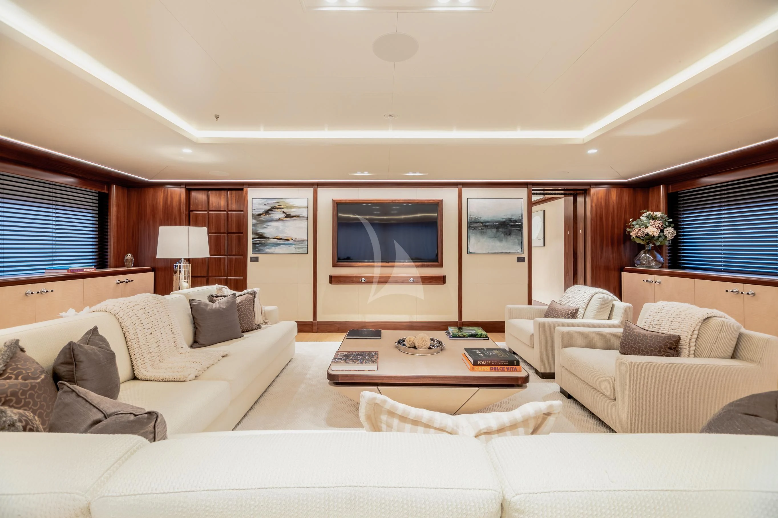 a living room with white couches aboard CALEX Yacht for Sale