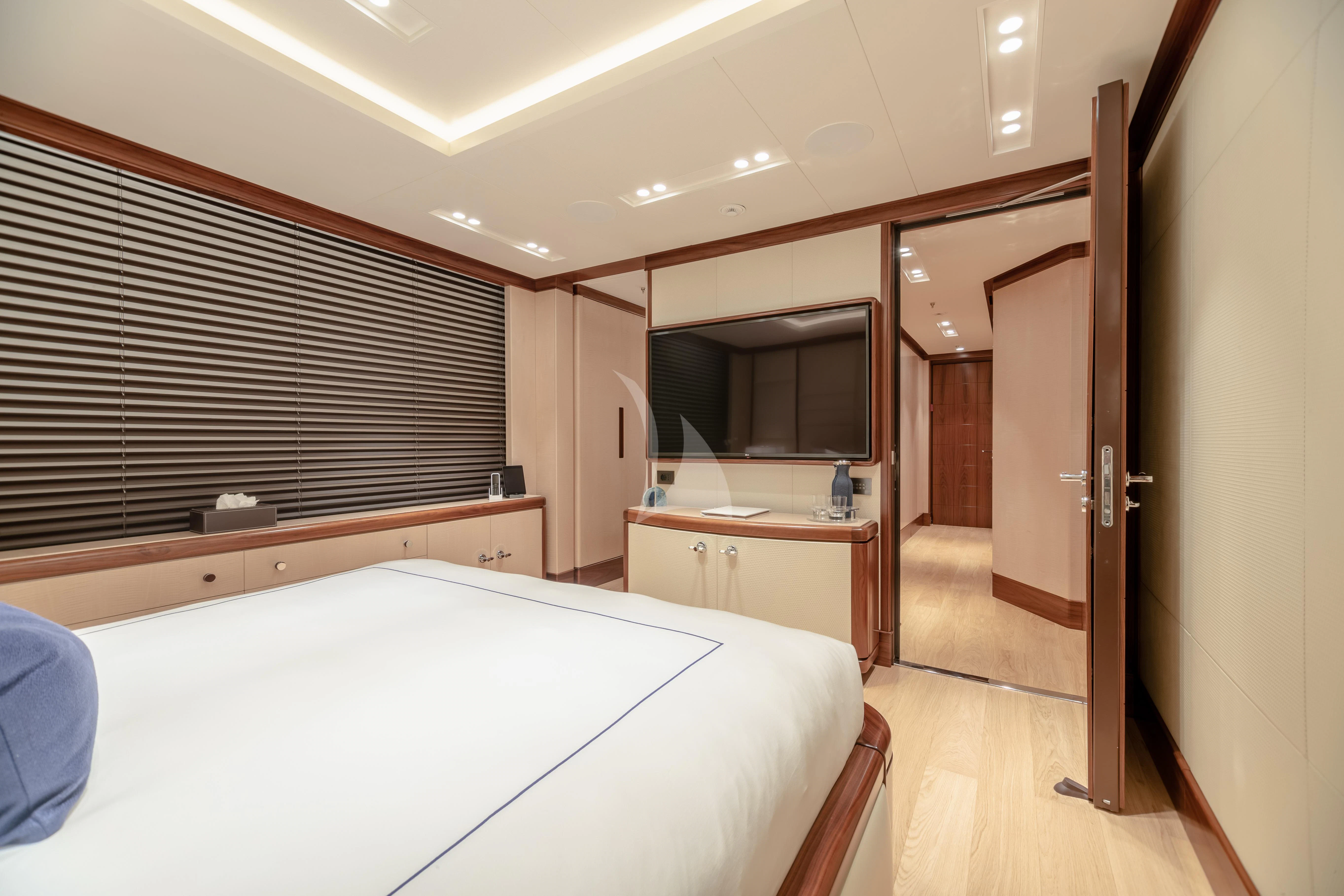 a room with a bed and a television aboard CALEX Yacht for Sale