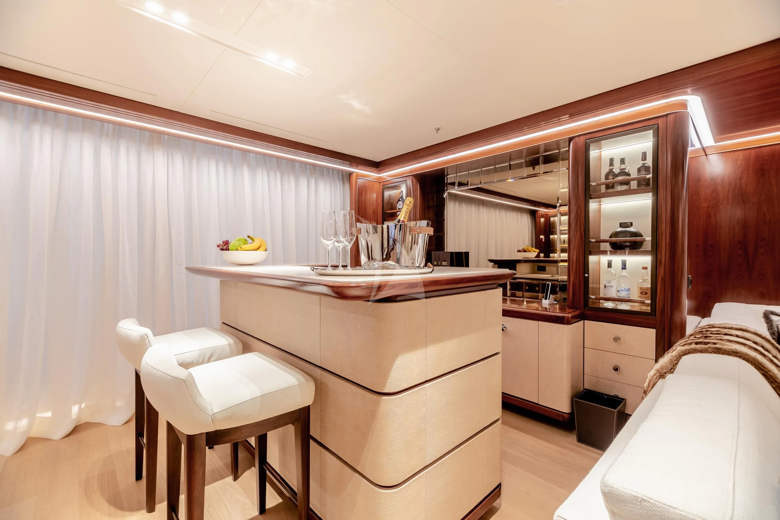 a kitchen with a sink and stools aboard CALEX Yacht for Sale