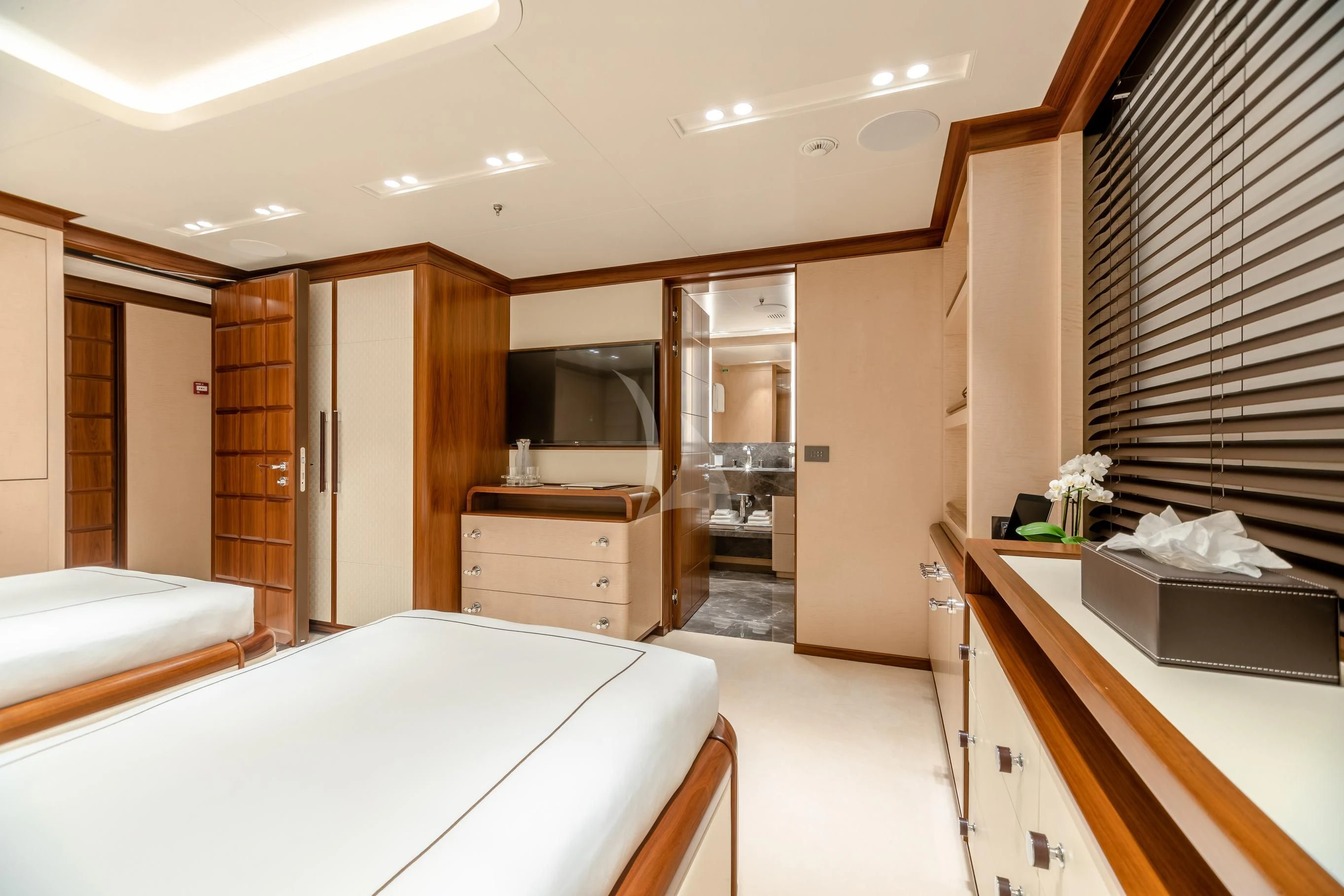 a room with a bed and a television aboard CALEX Yacht for Sale
