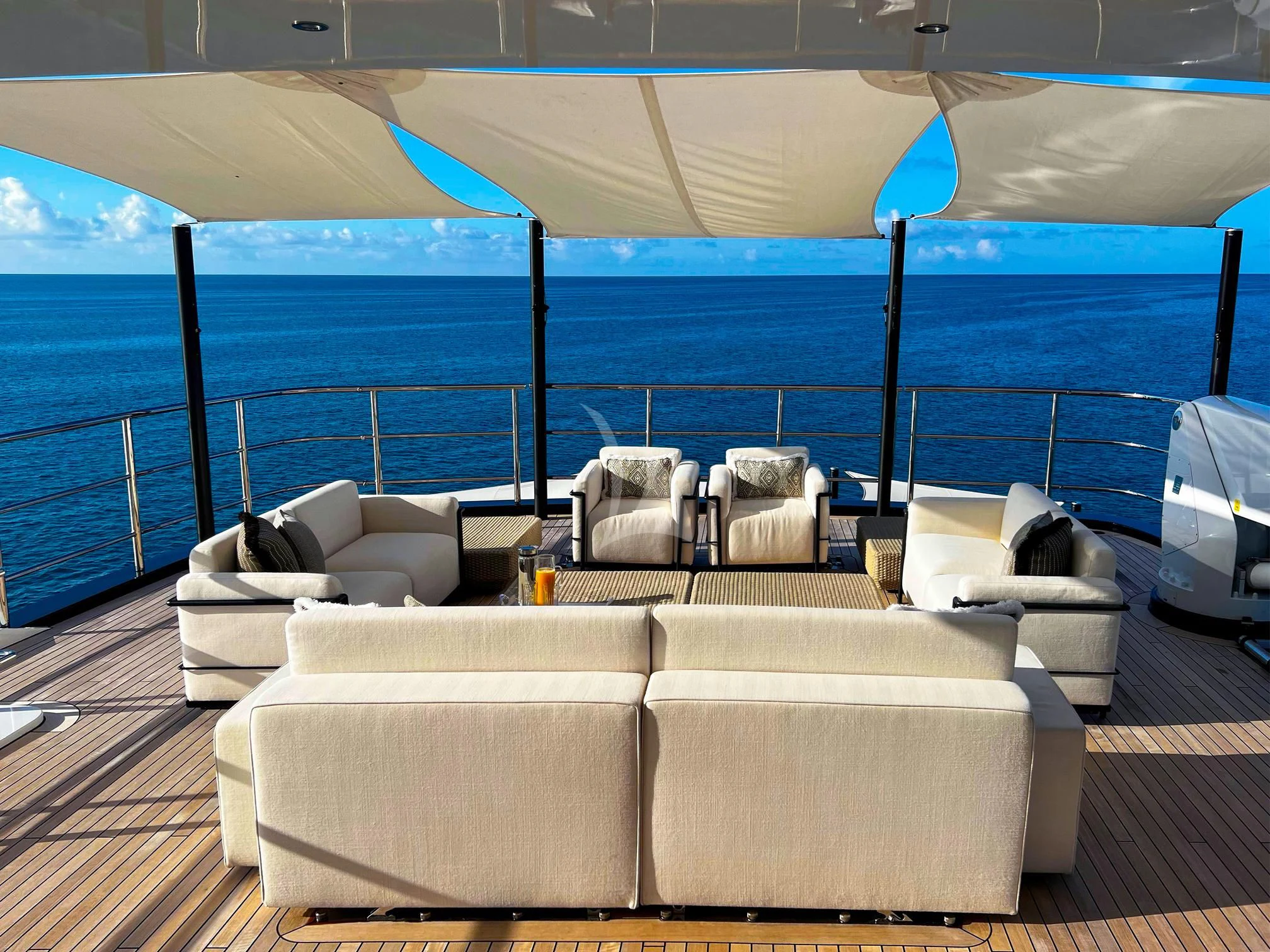a lounge area with a large umbrella aboard CALEX Yacht for Sale