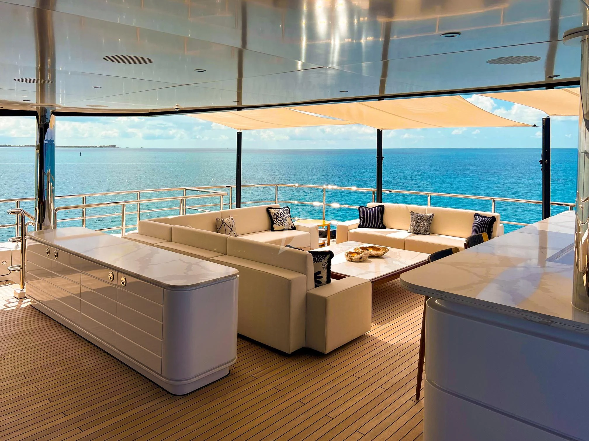 a room with a couch and a table and a large window aboard CALEX Yacht for Sale