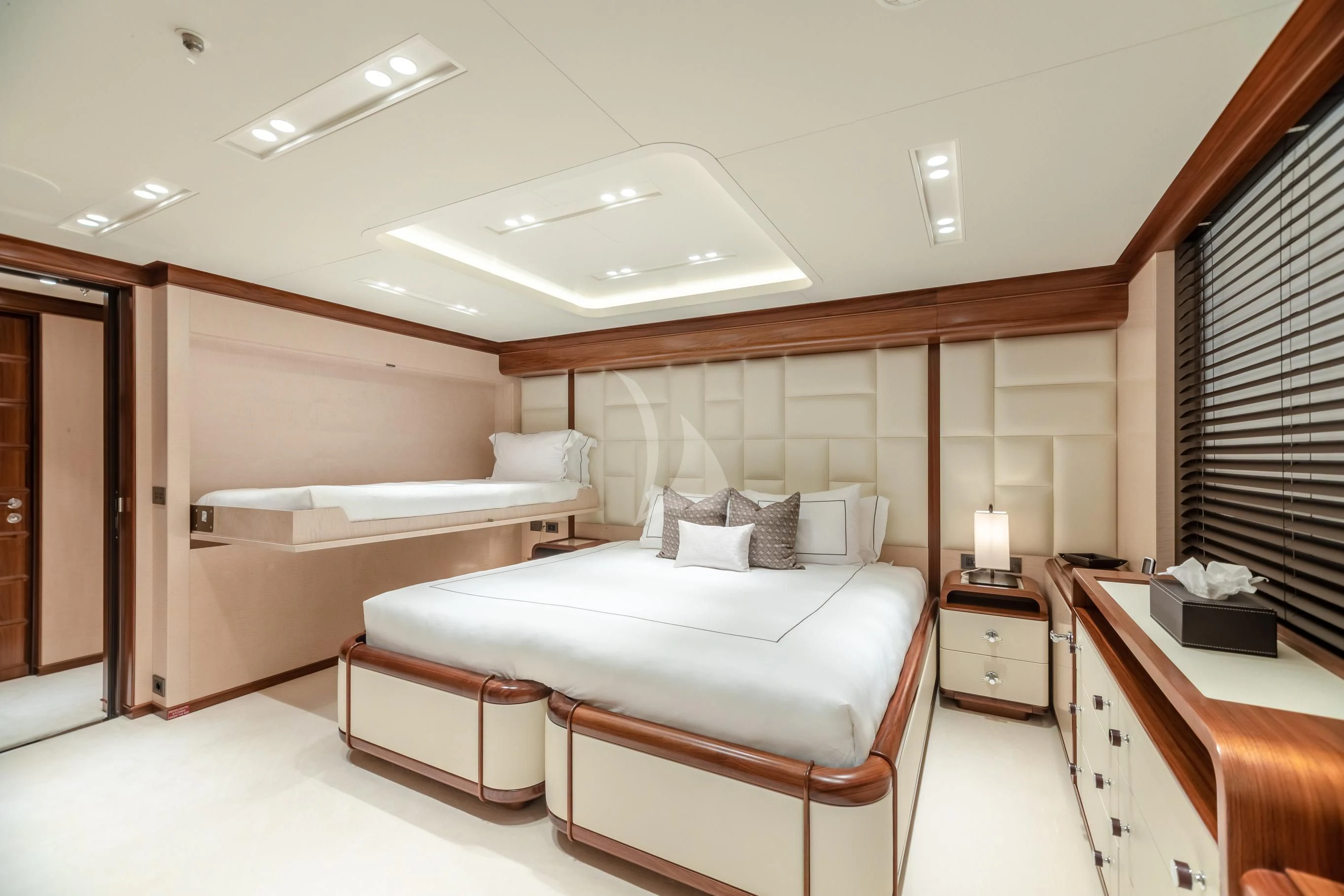 a room with a bed and a desk aboard CALEX Yacht for Sale