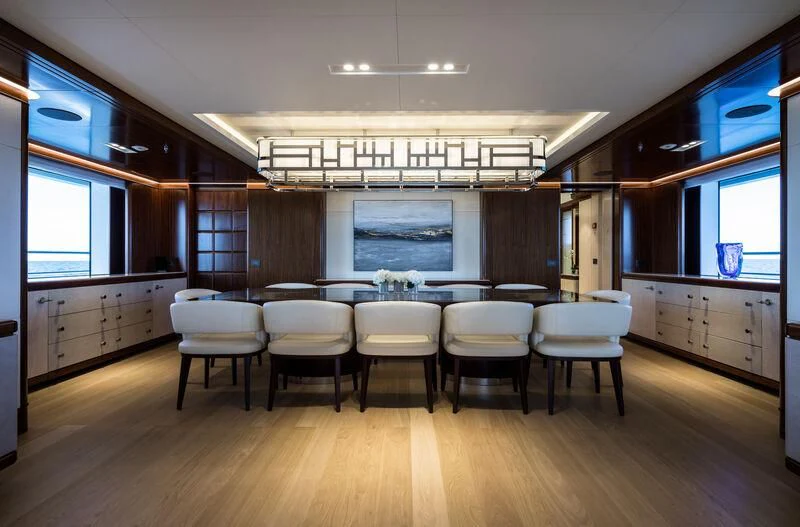 a room with a table and chairs aboard CALEX Yacht for Sale