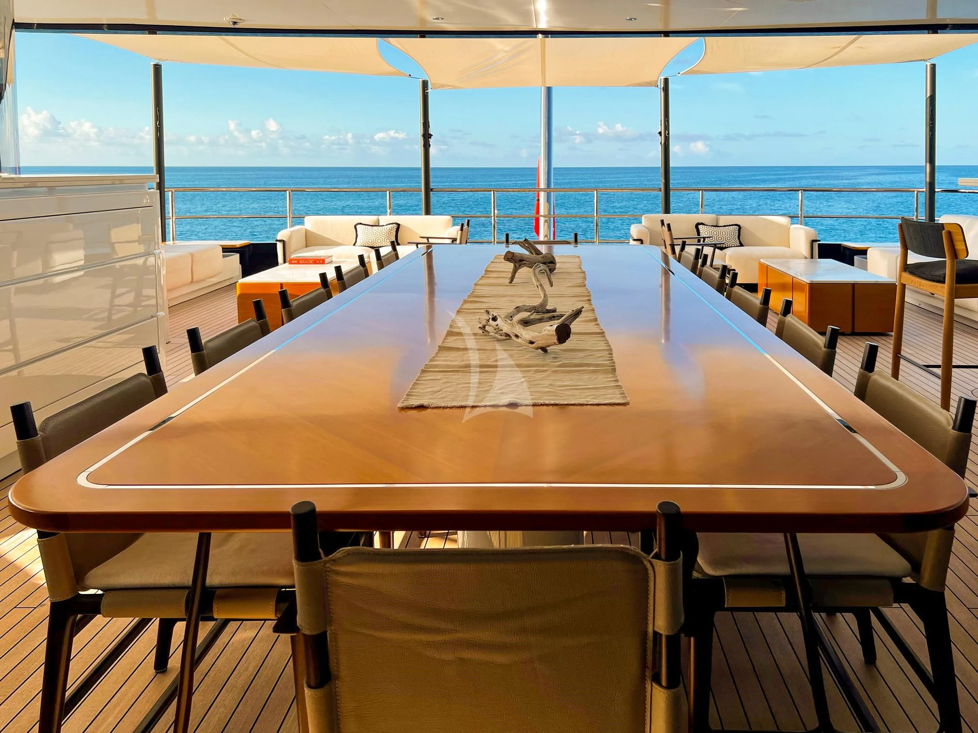 a table with chairs around it aboard CALEX Yacht for Sale