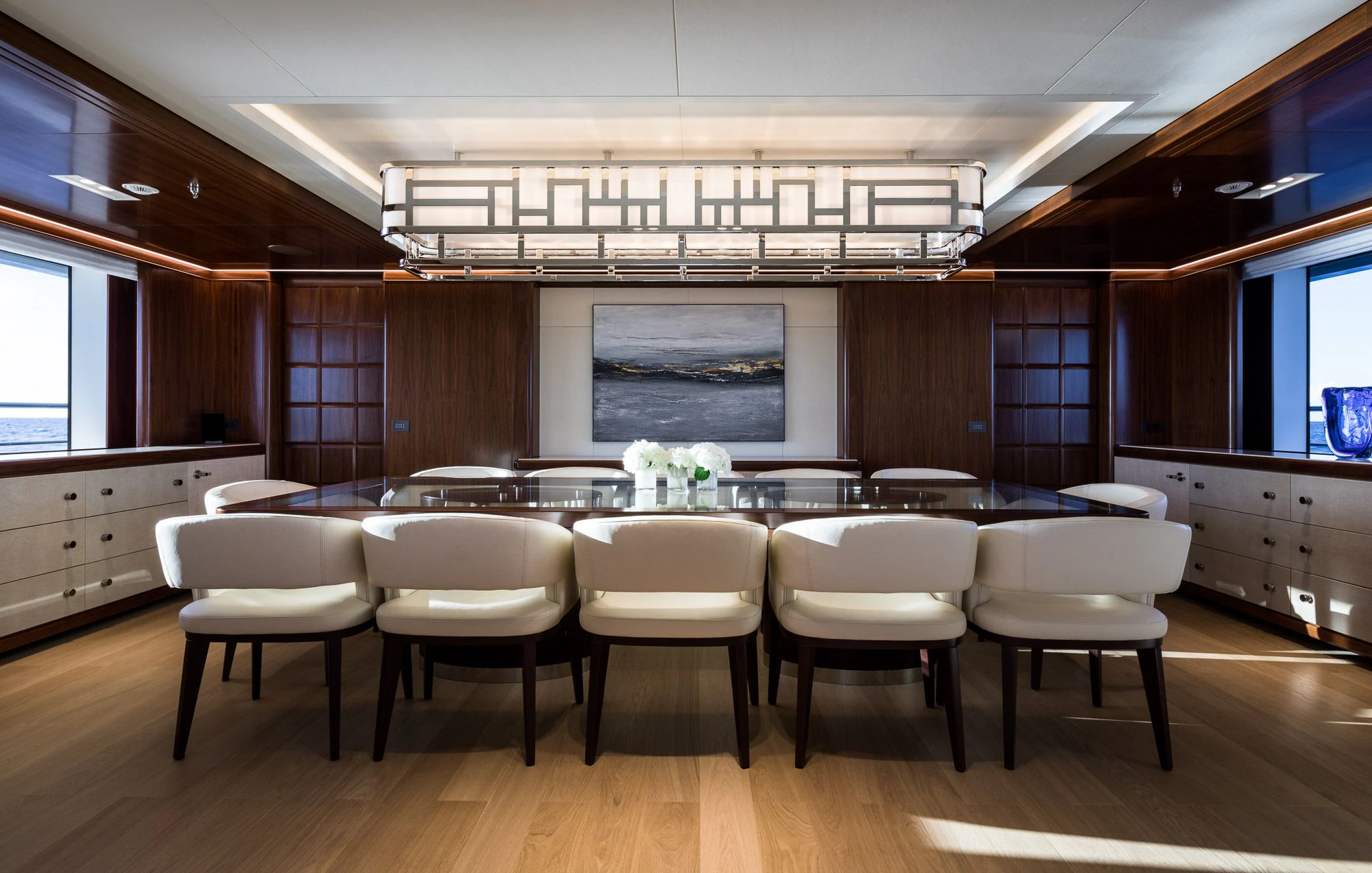 a large room with a table and chairs aboard CALEX Yacht for Sale