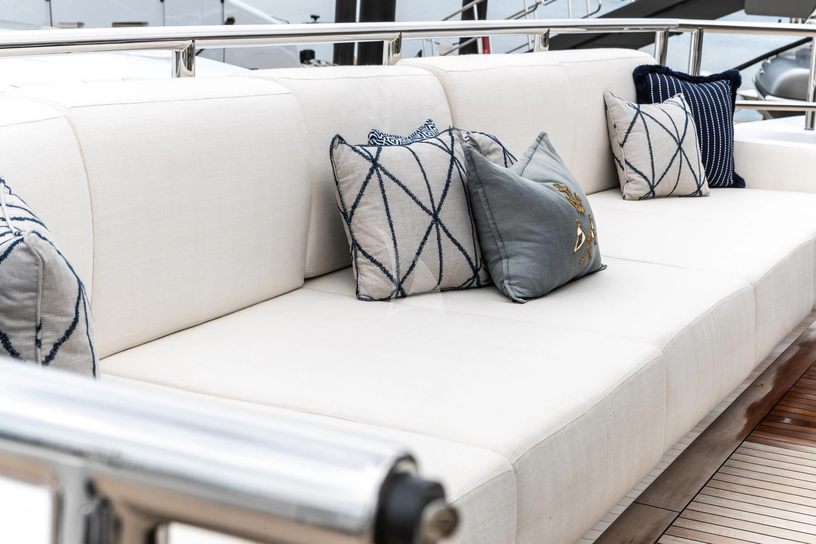 a white couch with pillows aboard CALEX Yacht for Sale