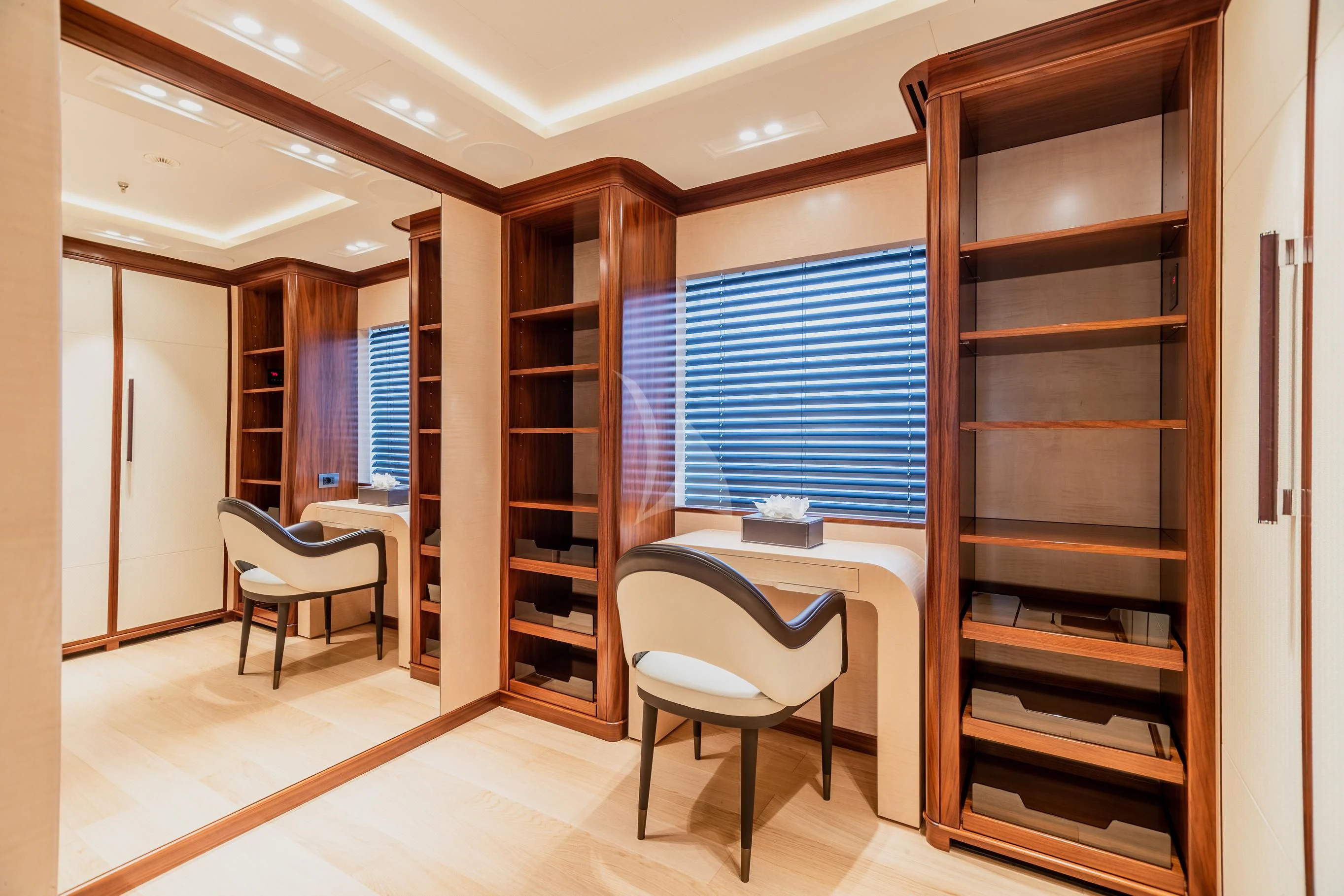 a room with a bed and desk aboard CALEX Yacht for Sale