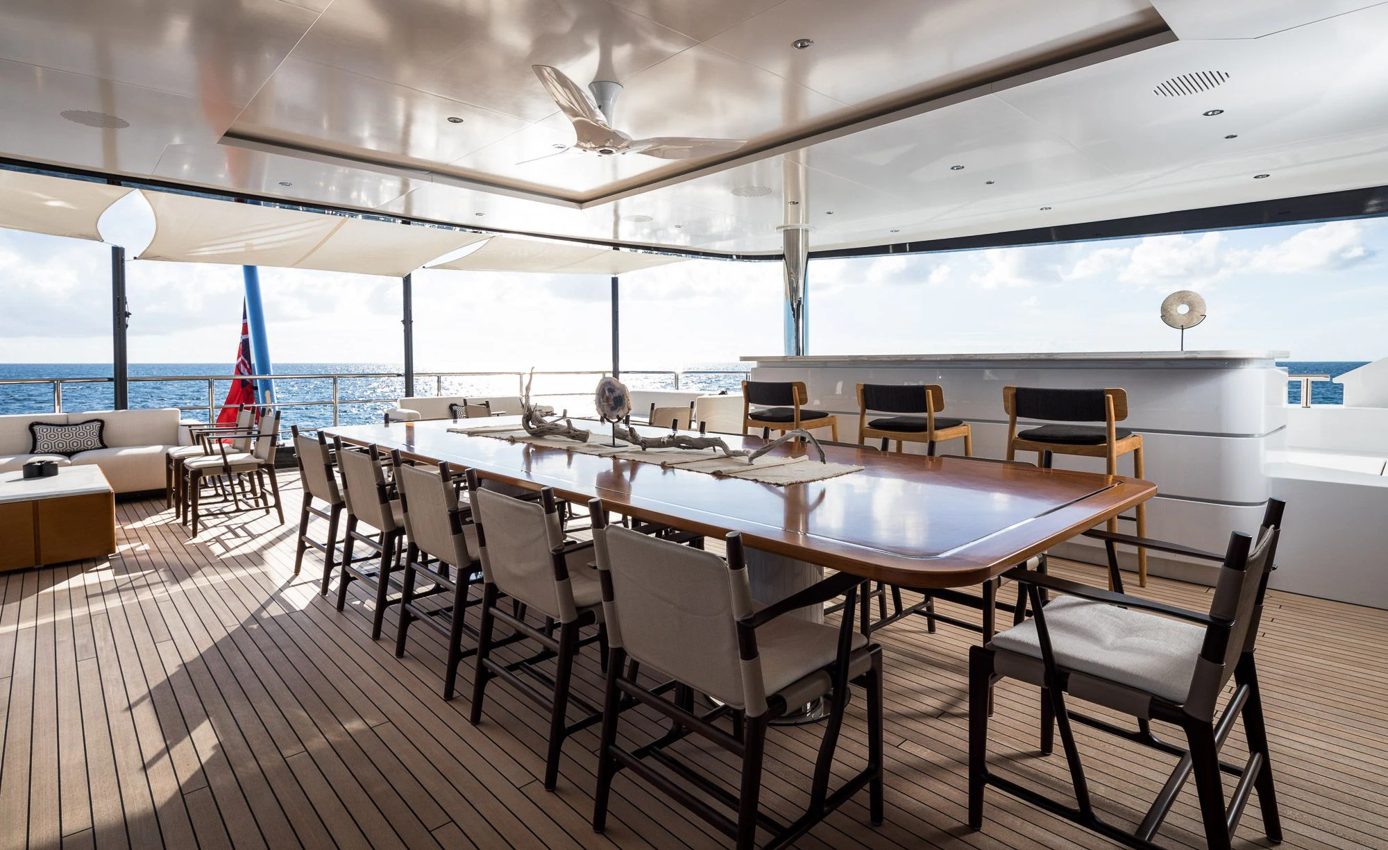 a large dining table with chairs around it aboard CALEX Yacht for Sale