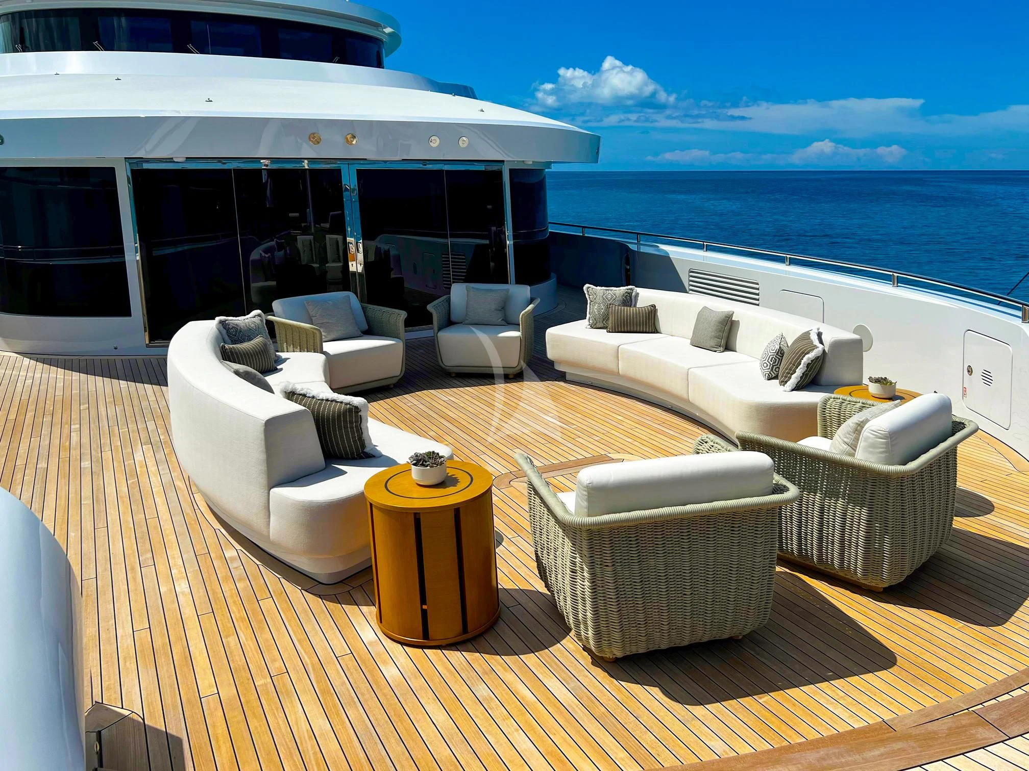 a room with a couch and a table and a large body of water aboard CALEX Yacht for Sale