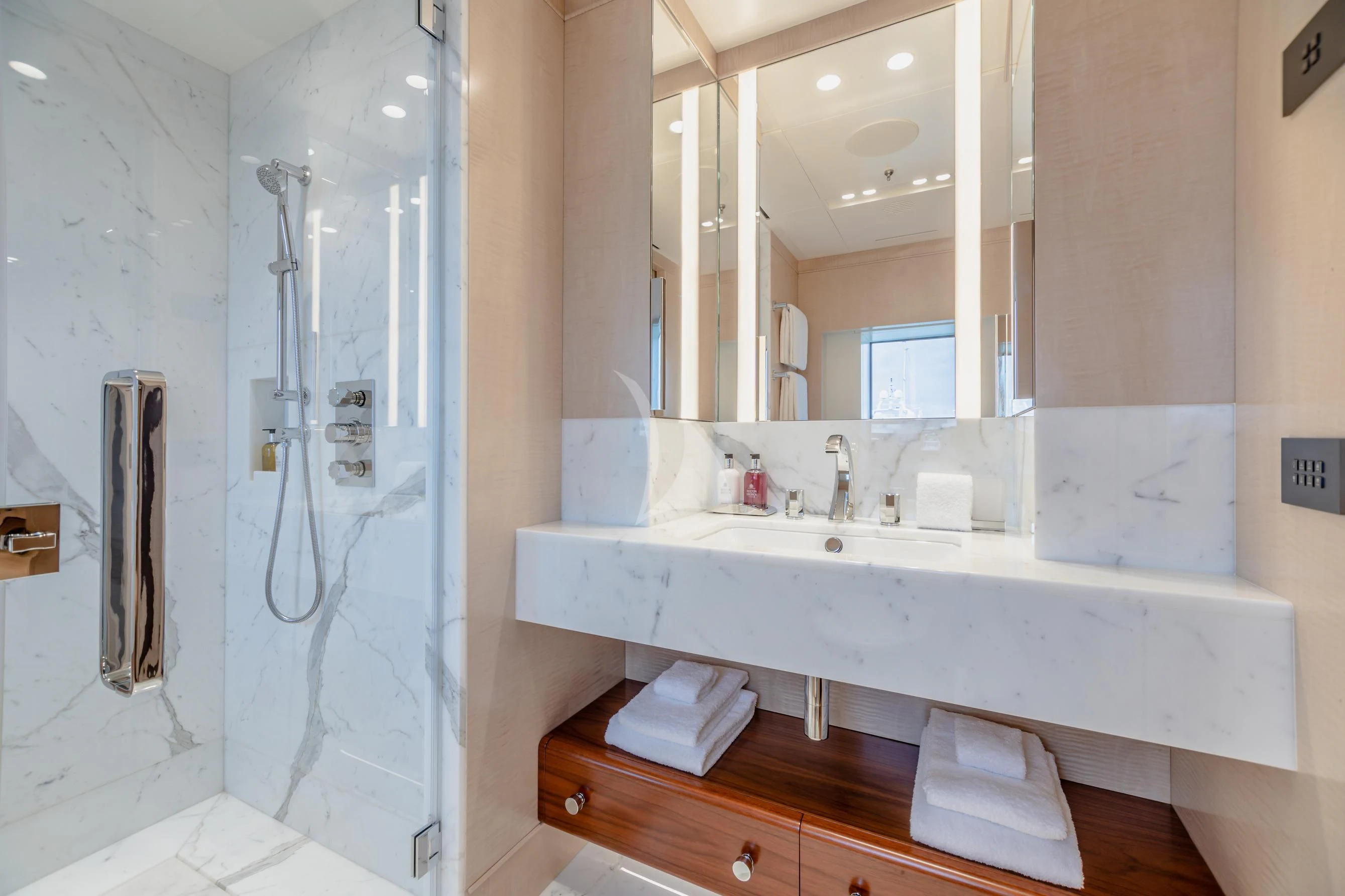 a bathroom with a sink and mirror aboard CALEX Yacht for Sale