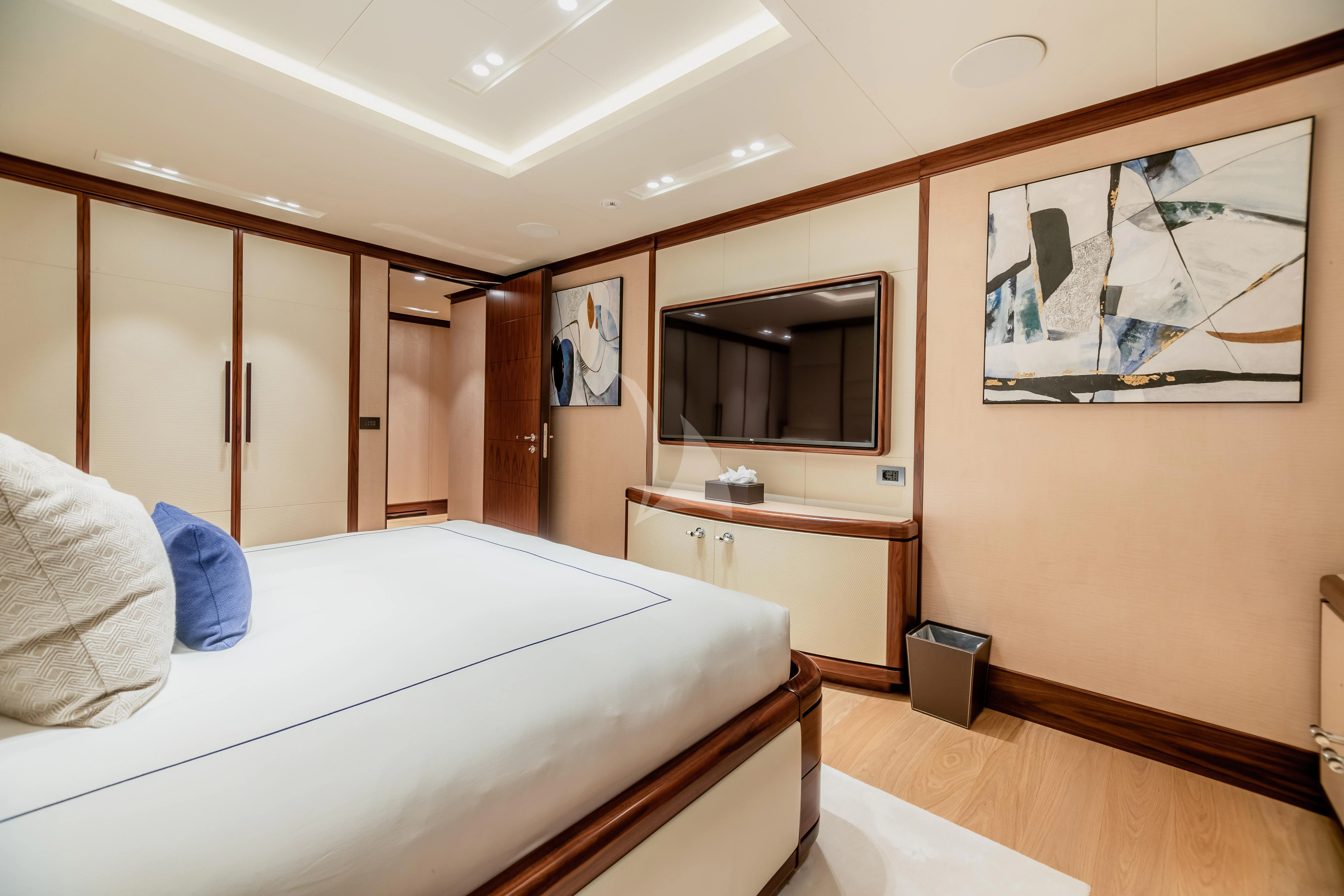 a bedroom with a bed and a television aboard CALEX Yacht for Sale