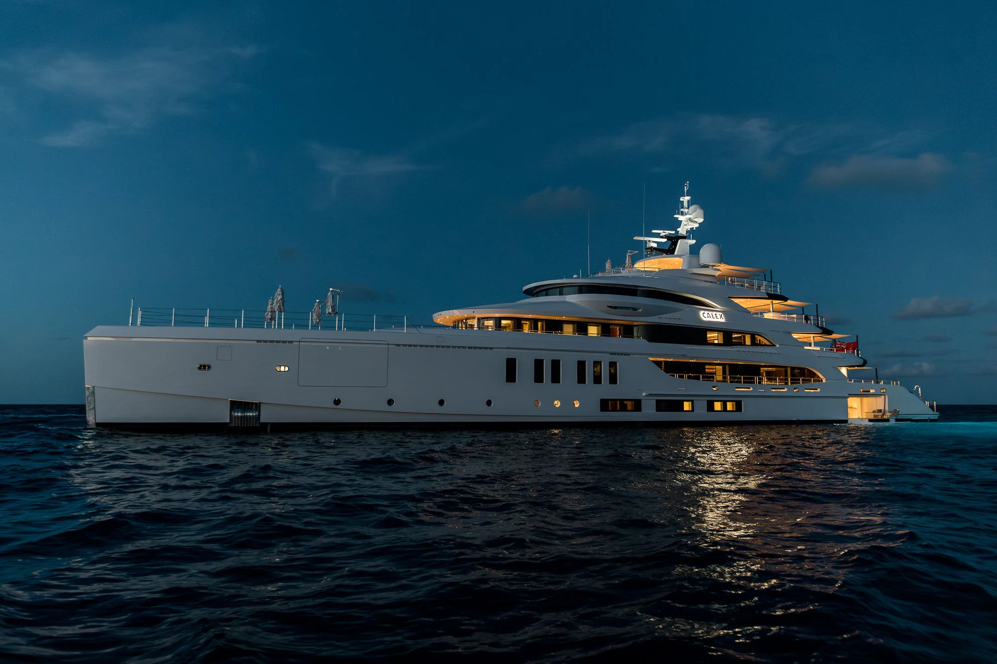 a large white ship in the water aboard CALEX Yacht for Sale