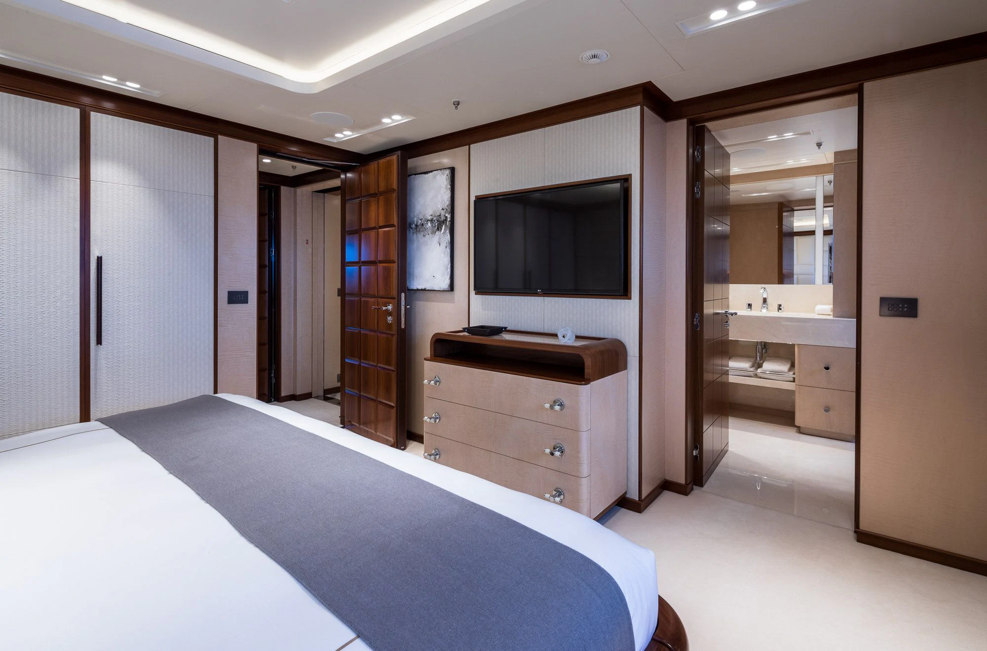 a large room with a bed and a tv aboard CALEX Yacht for Sale
