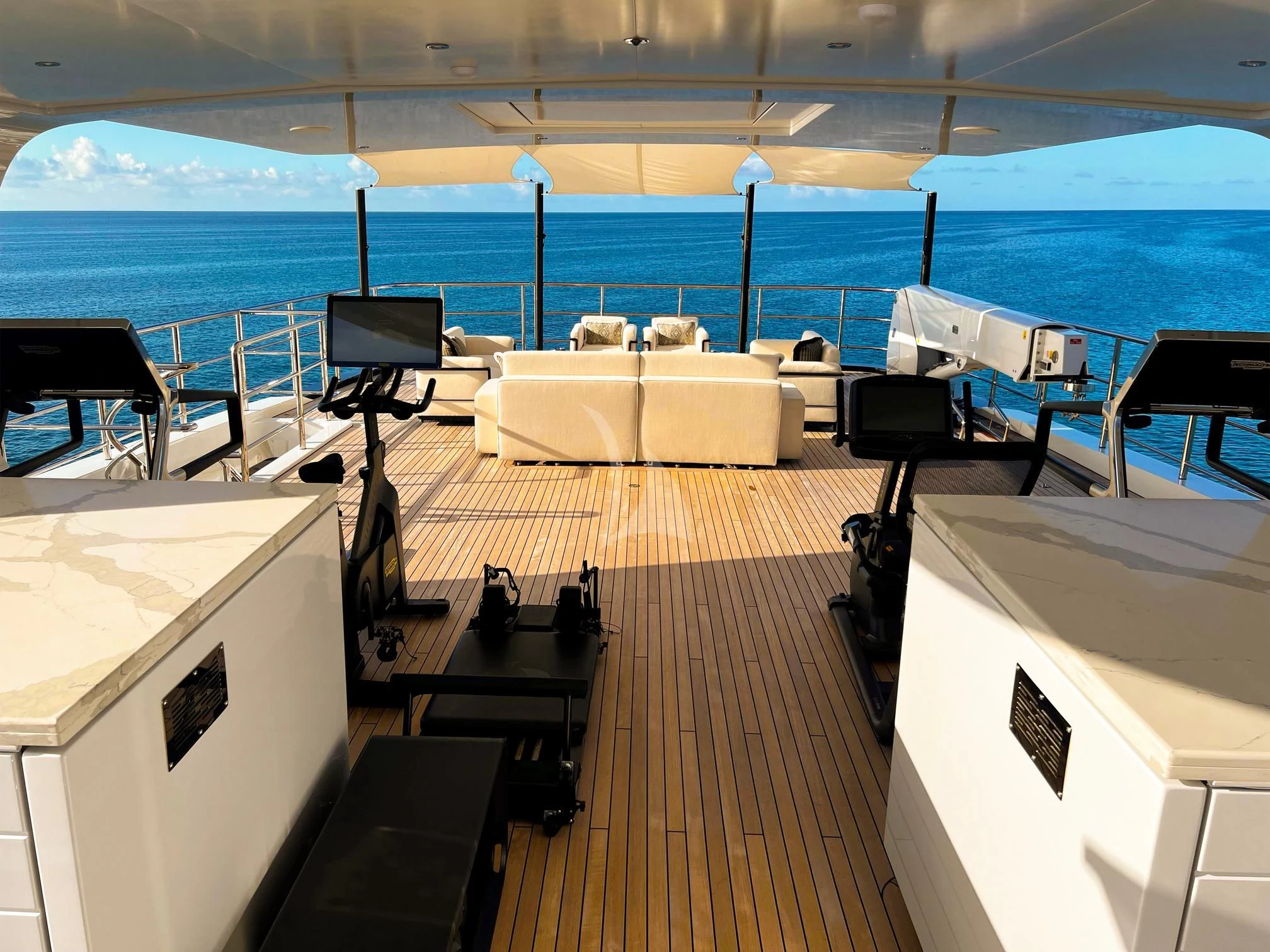 a room with a deck and chairs aboard CALEX Yacht for Sale
