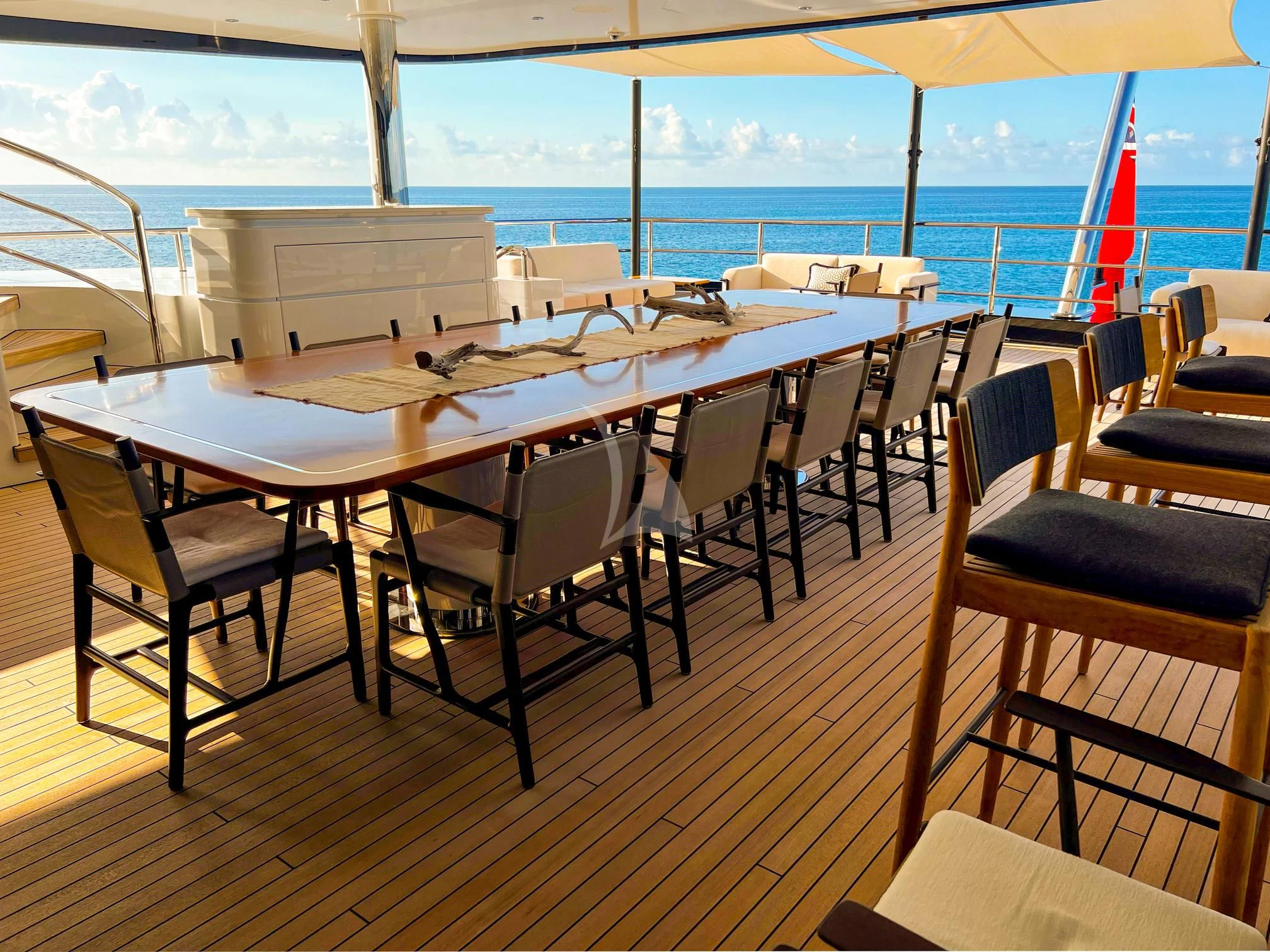 a table with chairs on it aboard CALEX Yacht for Sale