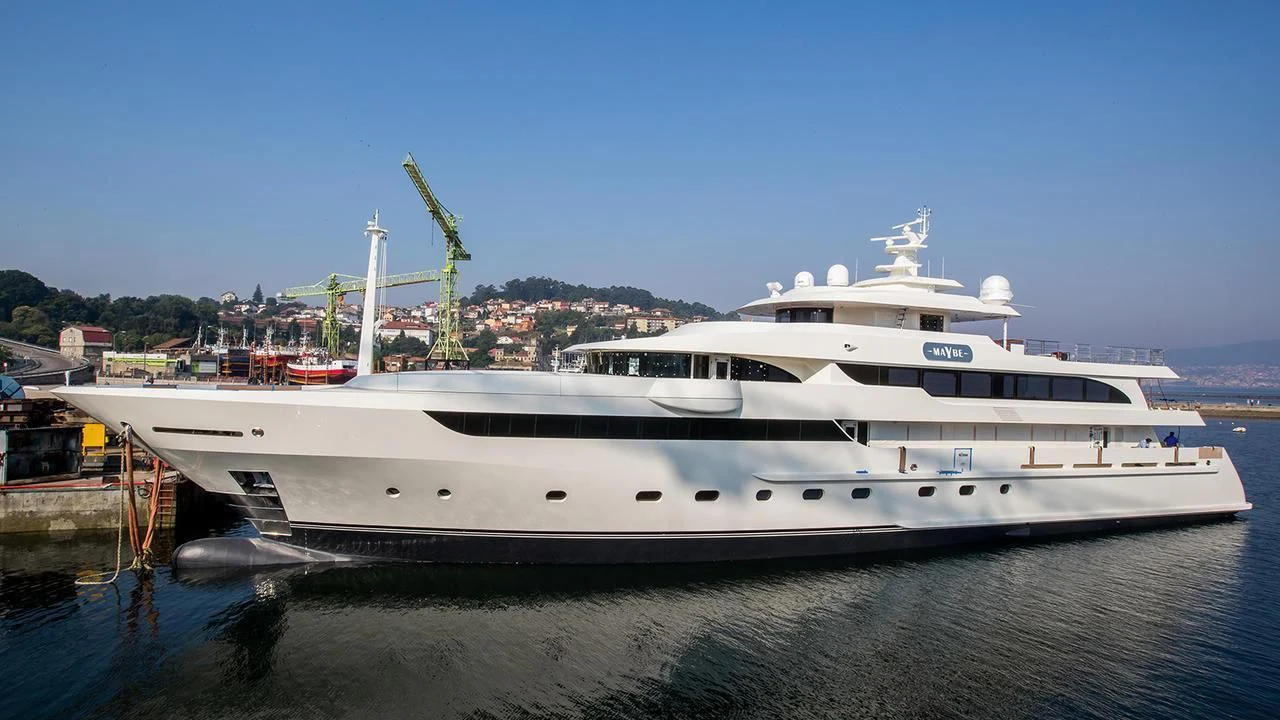 a large white yacht docked at a dock aboard MAYBE Yacht for Sale