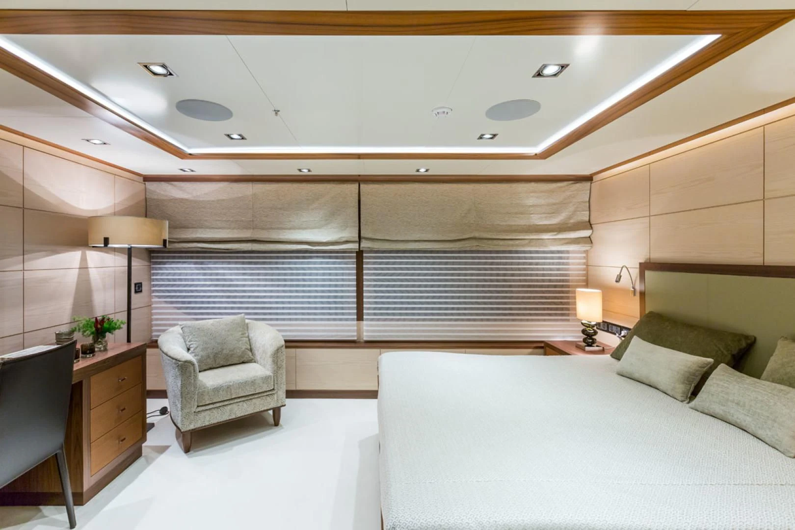 a room with a bed and a chair aboard MAYBE Yacht for Sale
