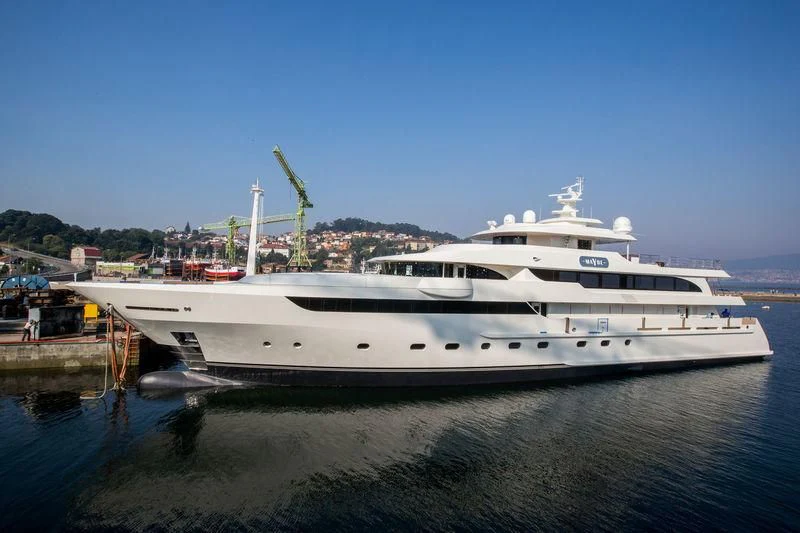 a large white yacht docked at a dock aboard MAYBE Yacht for Sale