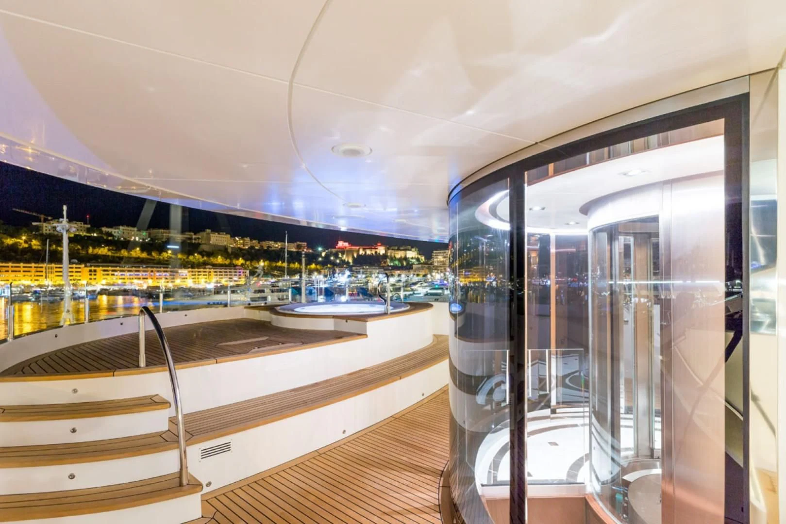 a glass wall with a view of a city aboard MAYBE Yacht for Sale