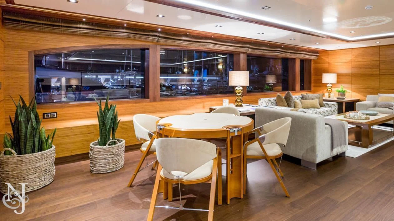 a room with a table and chairs aboard MAYBE Yacht for Sale