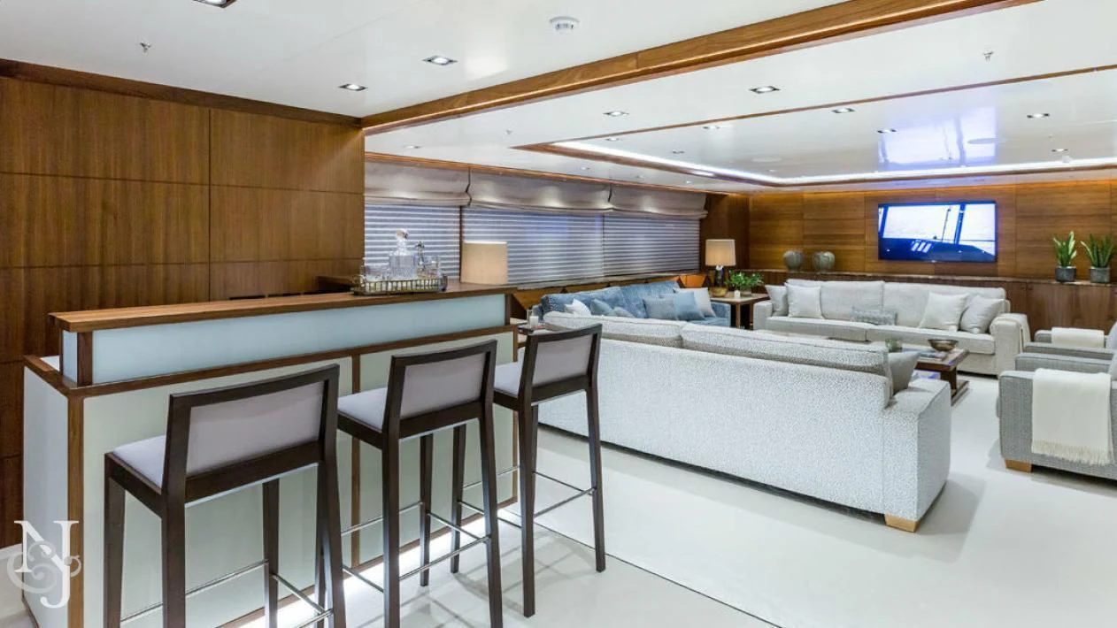 a room with a couch and a table and chairs aboard MAYBE Yacht for Sale