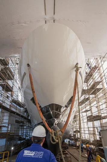 a man working on a large white machine aboard MAYBE Yacht for Sale