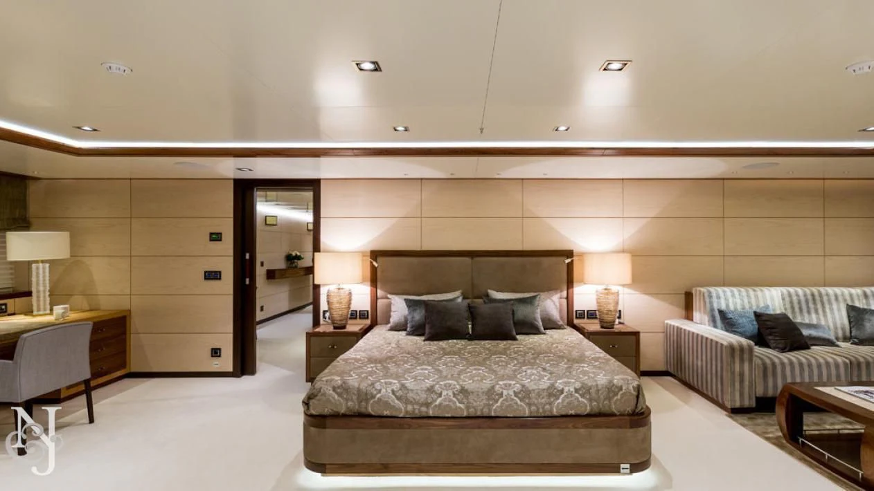 a bedroom with a bed and a couch aboard MAYBE Yacht for Sale