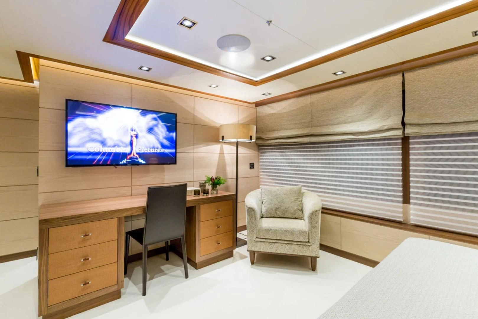 a room with a tv and a chair aboard MAYBE Yacht for Sale