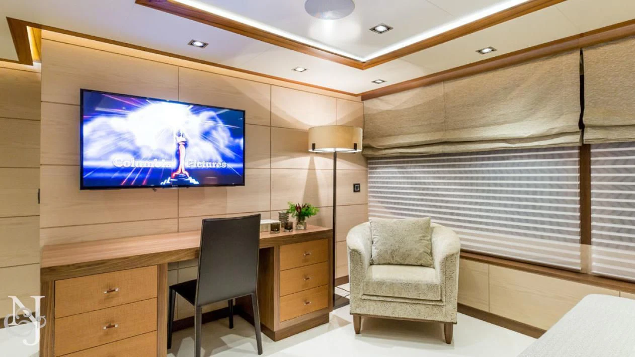 a room with a tv and a chair aboard MAYBE Yacht for Sale