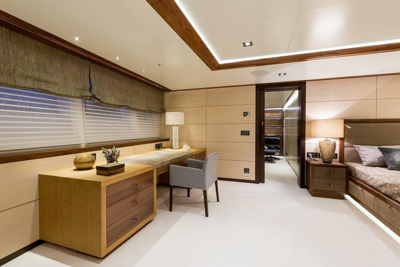 a bedroom with a bed and desk aboard MAYBE Yacht for Sale