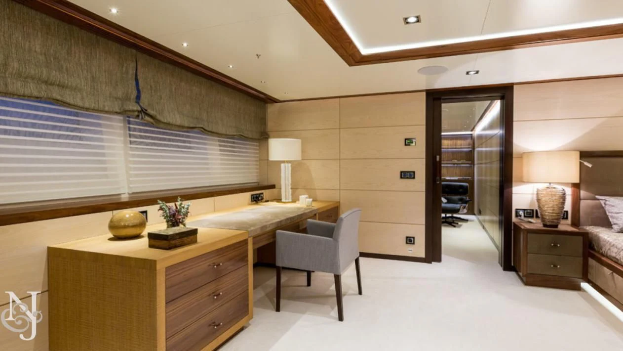 a room with a desk and a bed aboard MAYBE Yacht for Sale