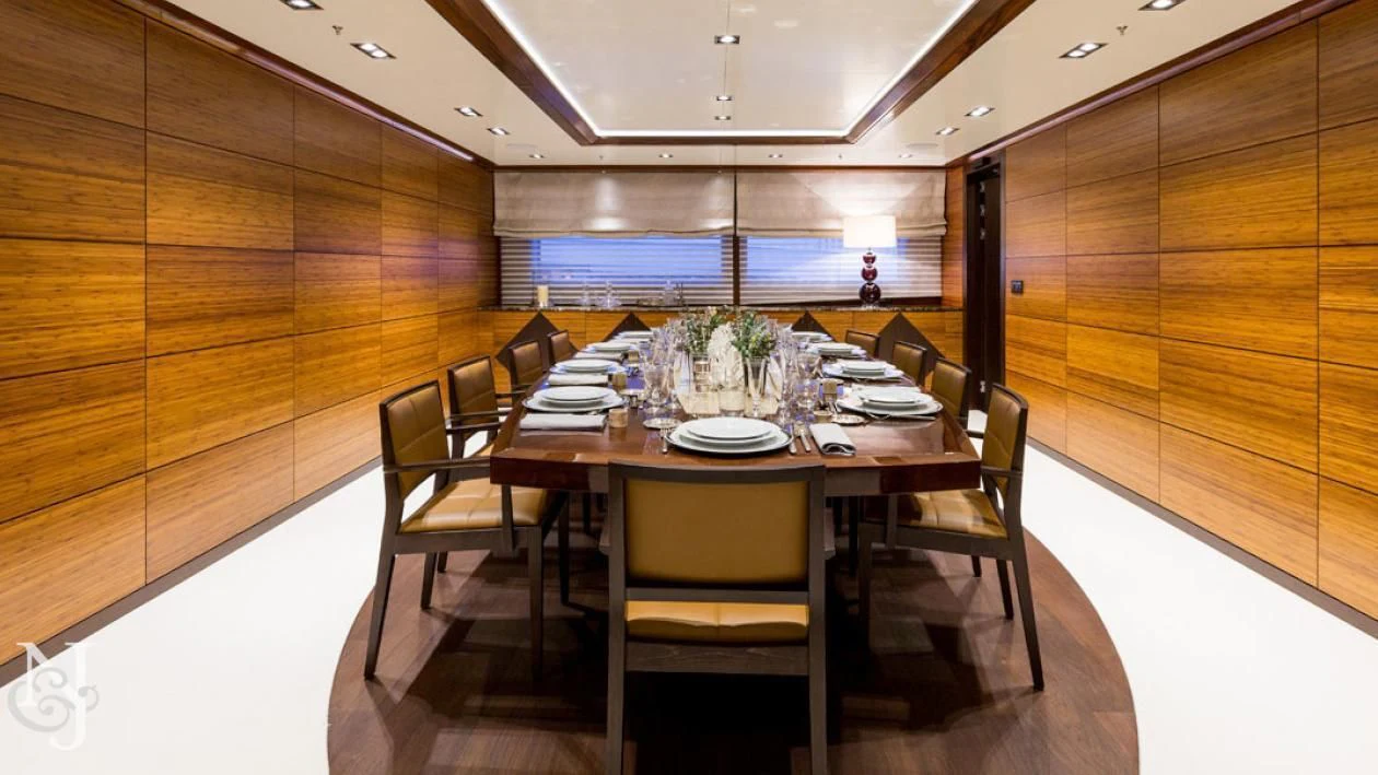 a dining room with a table and chairs aboard MAYBE Yacht for Sale