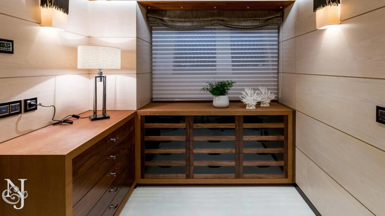 a desk with a lamp and a window aboard MAYBE Yacht for Sale