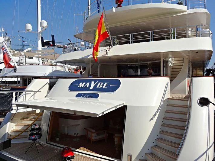 a boat with a flag on the front aboard MAYBE Yacht for Sale