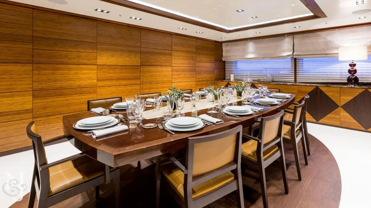 a dining table set for a dinner aboard MAYBE Yacht for Sale