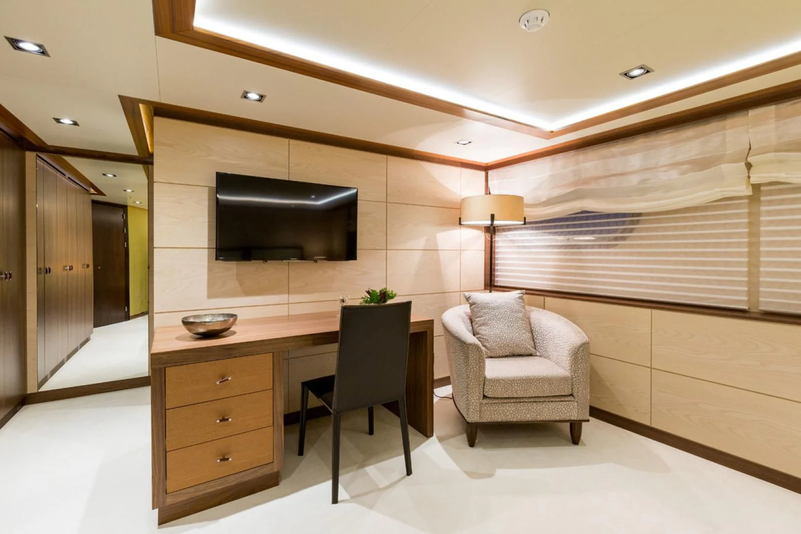 a room with a tv and a chair aboard MAYBE Yacht for Sale