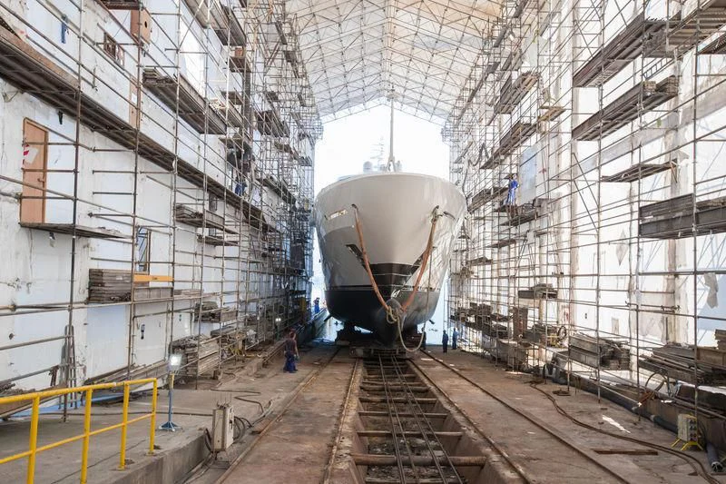 a large white ship in a factory aboard MAYBE Yacht for Sale